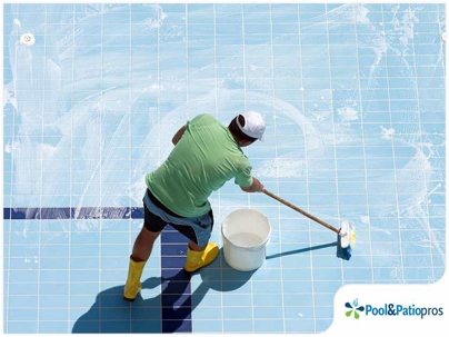 Pool man cleaning the bottom of a swimming pool